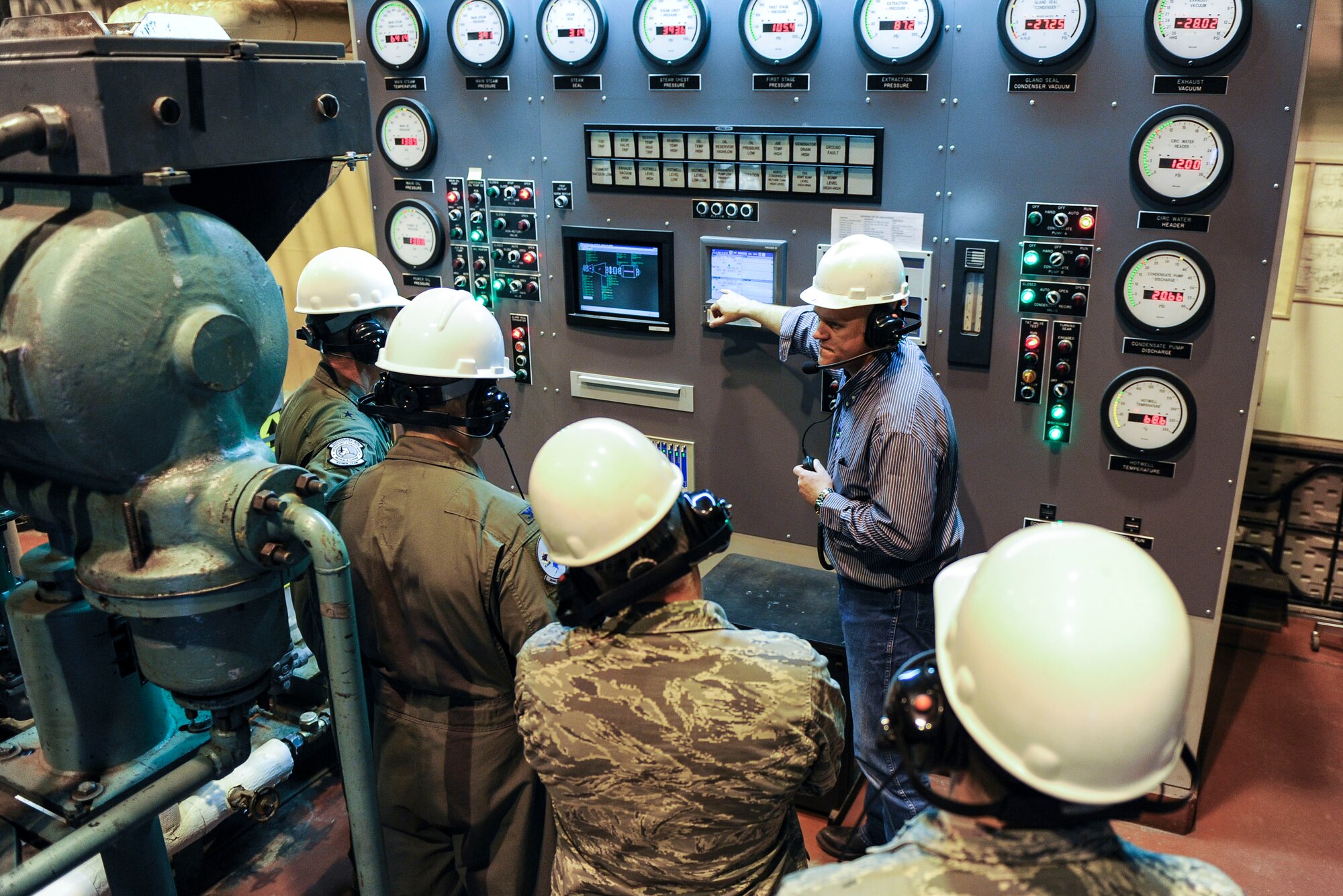 Marty Overlin, 354th Civil Engineer Squadron central heat and power superintendent, talks about the operating panel for turbine five with 354th Fighter Wing commanders during a tour of the central heat and power plant Oct. 15, 2013, Eielson Air Force Base, Alaska. This unit was overhauled this summer, along with a new operating panel, and provides the majority of electricity and heat for the Eielson community. (U.S. Air Force photo by Senior Airman Joshua Turner/Released)