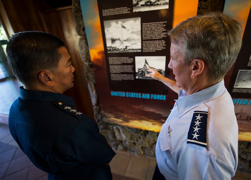 Gen. Hawk Carlisle, Pacific Air Forces commander, discusses Pacific Air Forces military history in the entryway of the PACAF headquarters building with Lt. Gen. Lauro Catalino G. Dela Cruz, Commanding General of the Philippine Air Force, Oct. 16, 2013, at Joint Base Pearl Harbor-Hickam, Hawaii. Dela Cruz and four PAF delegation members were provided a PACAF command brief and tours of the 613th Air Operations Center, the 19th and 199th Fighter Squadrons at JBPH-Hickam, and the Hawaii Region Air Operations Center at Wheeler Army Air Field. (U.S. Air Force photo/Staff Sgt. Nathan Allen)