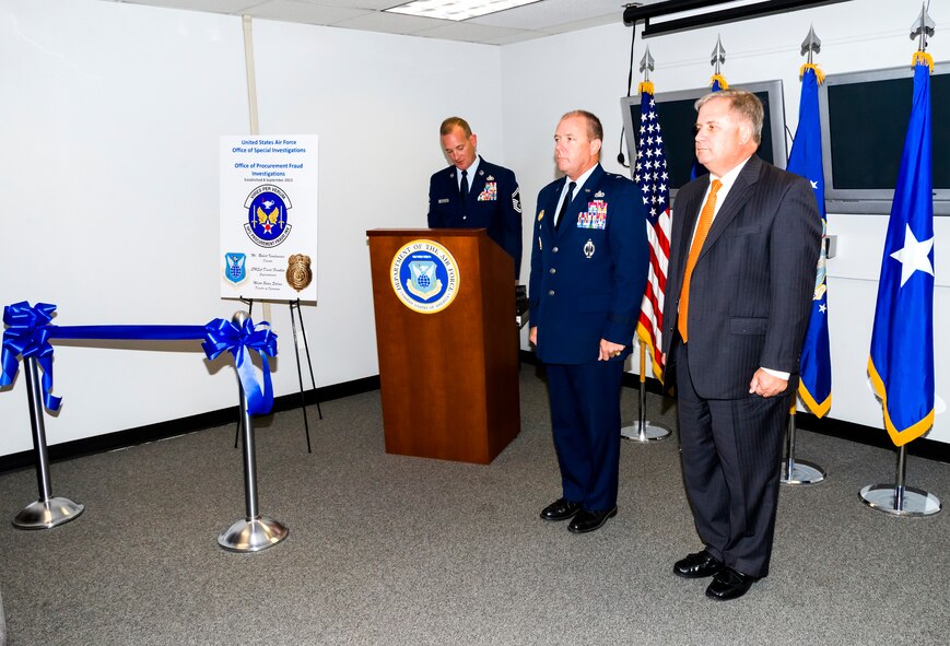 Brig. Gen. Kevin J. Jacobsen, Air Force Office of Special Investigations commander, middle, and Mr. Bob Kwalwasser, OSI Office of Procurement Fraud director, right, stand by during the PF office activation ceremony held October 17. With the creation of this new office, OSI will more effectively be able to centralize and consolidate procurement fraud investigations, which further promotes a renewed and sustained emphasis on combatting fraud.  (U.S. Air Force photo/Mike Hastings)
