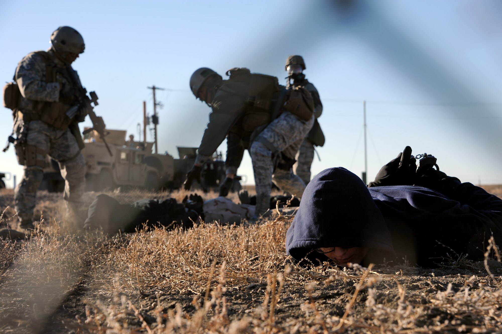 Three acting opposing force members are apprehended during a Launch Facility recapture exercise Oct. 15 near Power, Mont. Malmstrom Airmen protect 150 LFs spread across 13,800 square miles of Montana landscape. (U.S. Air Force photo/Staff Sgt. R.J. Biermann))