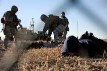 Three acting opposing force members are apprehended during a Launch Facility recapture exercise Oct. 15 near Power, Mont. Malmstrom Airmen protect 150 LFs spread across 13,800 square miles of Montana landscape. (U.S. Air Force photo/Staff Sgt. R.J. Biermann))