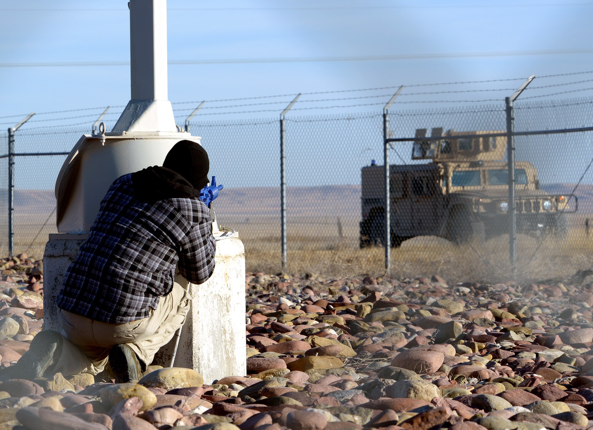 An acting opposing force member pretends to shoot at an initial responding team vehicle during a Launch Facility recapture exercise Oct. 15 near Power, Mont. Several 341st Security Forces Group and 40th Helicopter Squadron members participated in the exercise. (U.S. Air Force photo/Staff Sgt. R.J. Biermann)
