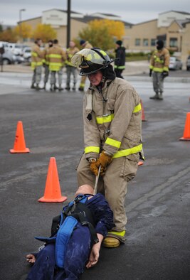 Airman 1st Class Greg Honadle, 341st Security Forces Squadron response force member, pulls a dummy during the Dummy Drag station at the Annual Fire Muster competition on Oct. 11 at the Base Exchange.  The Fire Muster is held annually to allow Team Malmstrom members a chance to see what Air Force firemen have to do for training.  (U.S. Air Force photo/Senior Airman Cortney Paxton)