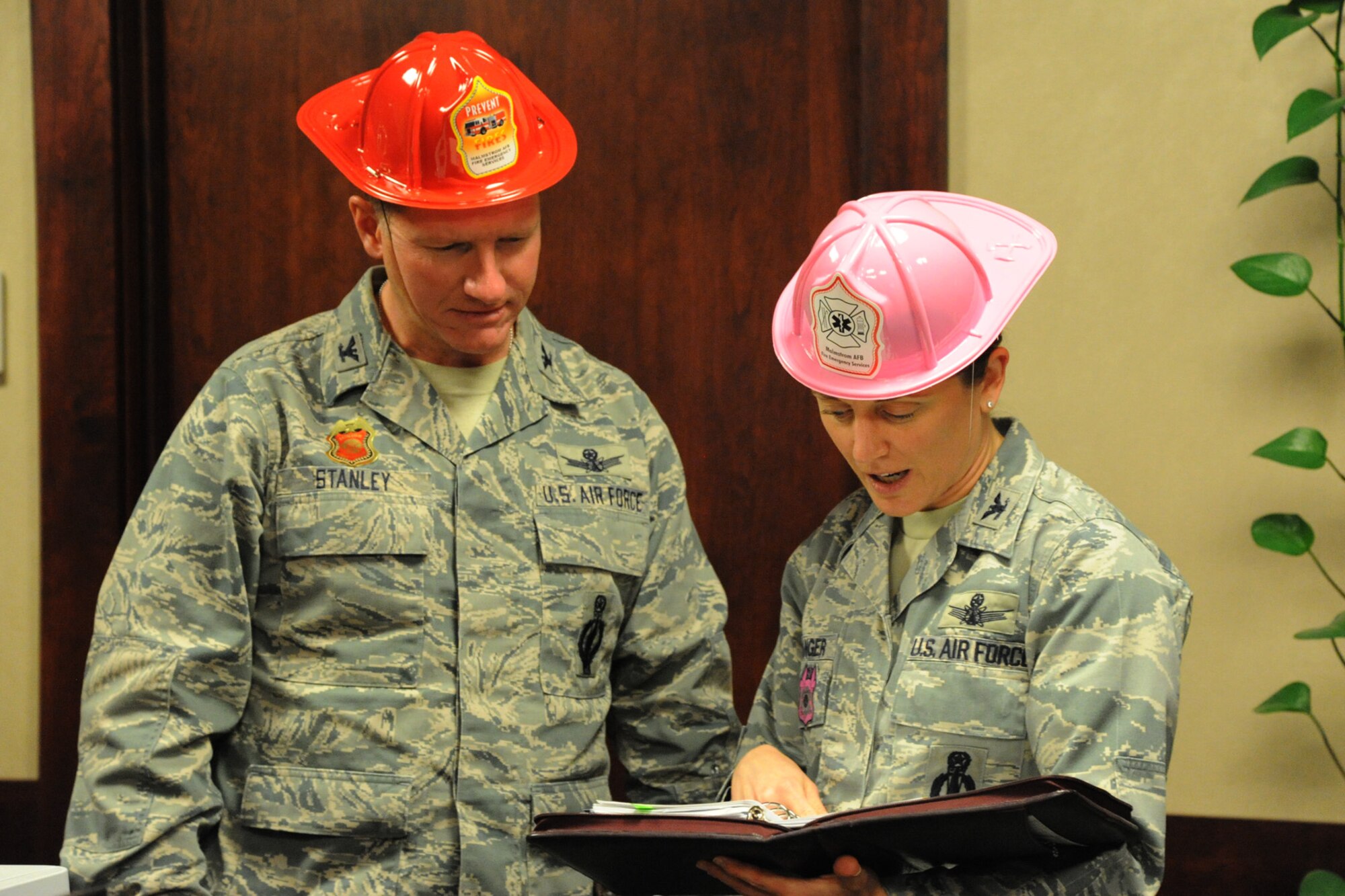 Col. Robert Stanley, 341st Missile Wing commander, and Col. Marné Deranger, 341st Missile Wing vice commander, have some fun in the office while working during Fire Prevention Week. Thursday Oct. 10. Both Stanley and Deranger took time throughout the week to meet with Airmen and discuss fire safety and prevention techniques. (U.S. Air Force photo/Airman 1st Class Collin Schmidt)