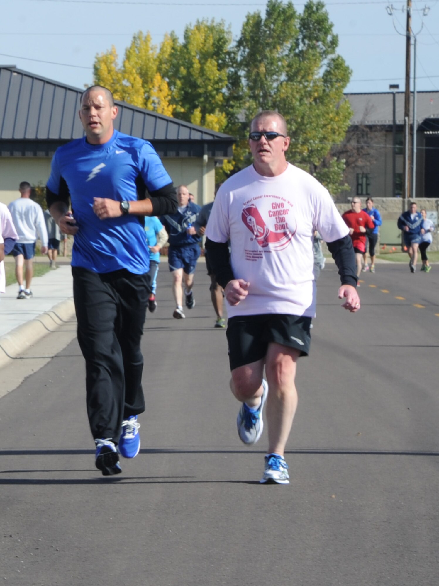Col. Robert Stanley, 341st Missile Wing commander, runs to the finish line during Malmstroms’s breast cancer awareness 5K event Oct. 10.  According to the American Cancer Society, one in eight women and one in 1,000 men in the United States will suffer from breast cancer in 2013. (U.S. Air Force photo/Airman 1st Class Collin Schmidt)