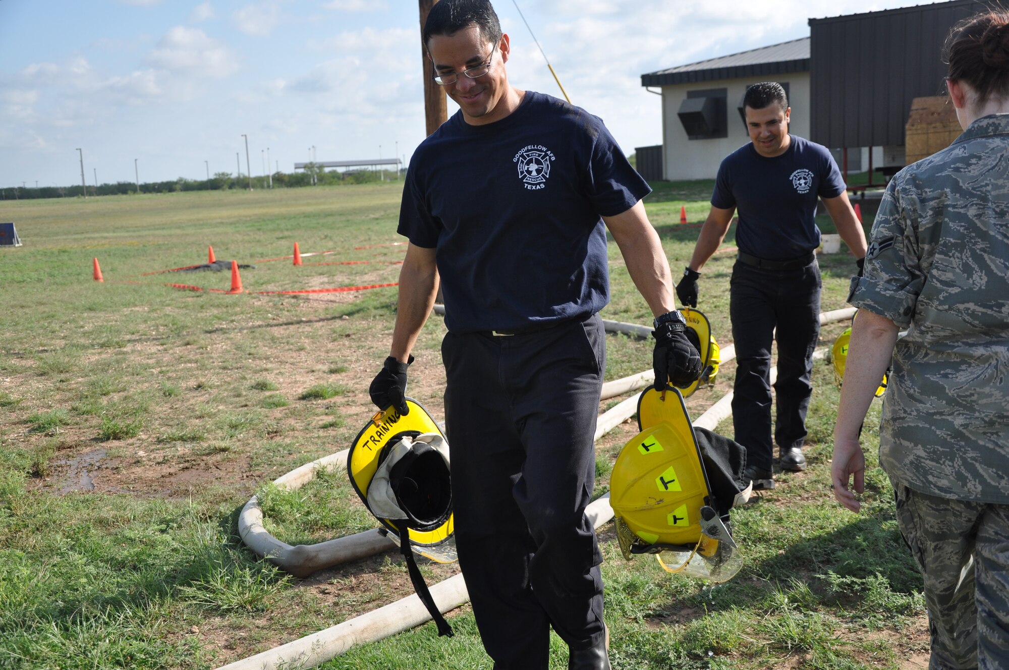 GOODFELLOW AIR FORCE BASE, Texas – Jason Garcia, 17th Civil Engineer Squadron fire inspector, carries firefighter helmets to the starting point of the 2013 Firefighter Muster at the fire station Oct. 11. The fire department hosted the competition as part of the 91st National Fire Prevention Week and to help raise awareness of fire safety. (U.S. Air Force photo/ Airman 1st Class Breonna Veal)
