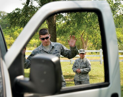 WRIGHT-PATTERSON AIR FORCE BASE, Ohio – Airman First Class Courtney Harry practices a felony traffic stop as Airman First Class Josh Huber exits his vehicle. Both are assigned to the 445th Security Forces Squadron. The scenario was part of the 445th SFS training exercise held Sept. 6-7 at Powell Park near here. (U.S. Air Force photo/Tech. Sgt. Frank Oliver)