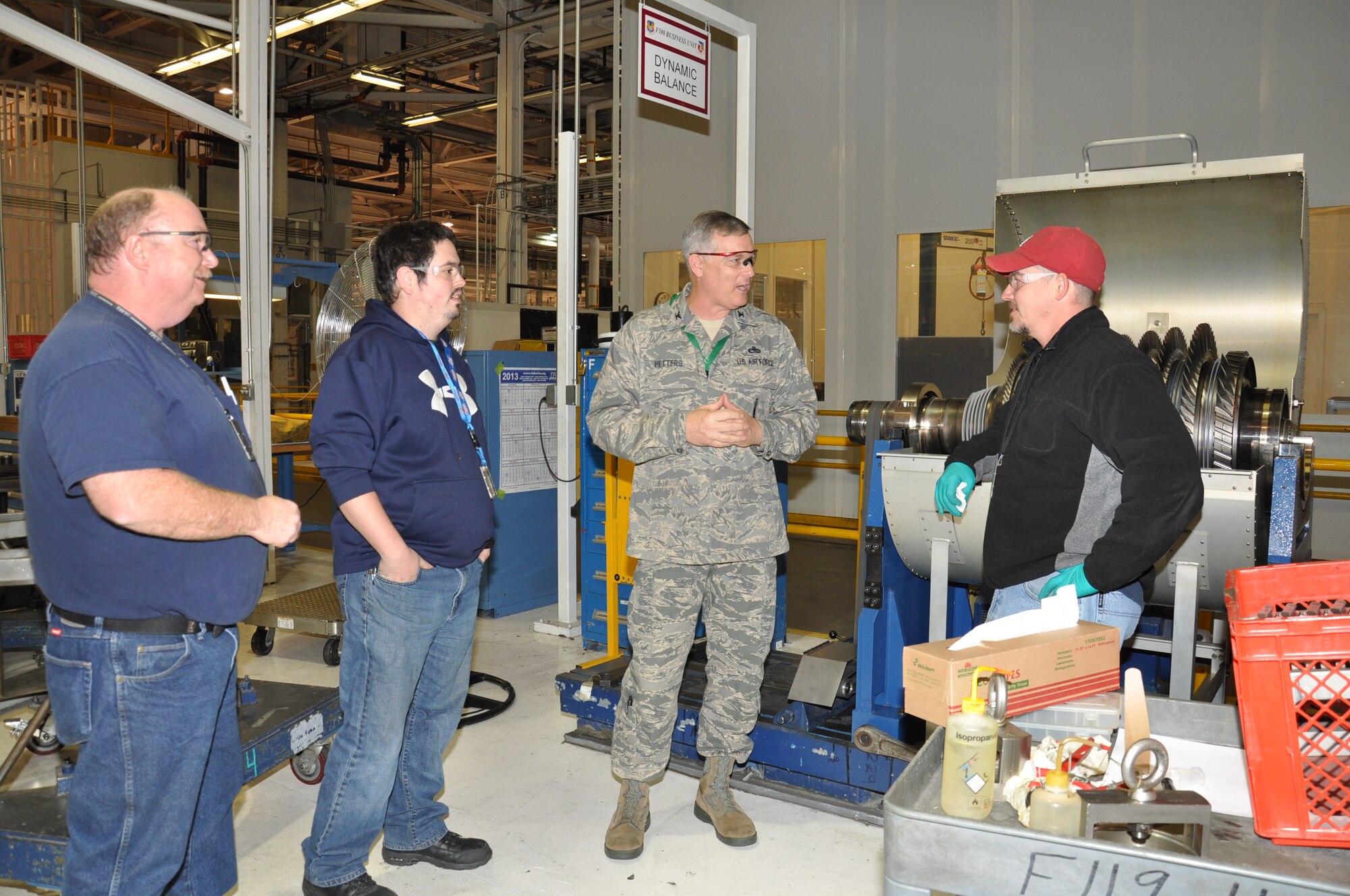 Col Steven Petters, 76th Propulsion Maintenance Group commander, visits with Chris White, Rick Stone and Steve McKinney in the F100 Rotor Shop. Commanders accros the Air Force Sustainment Center units at Tinker spent time with their people to reset focus on the mission after the stresses created by the government shutdown. (Air Force photo by Julie LaFollette)