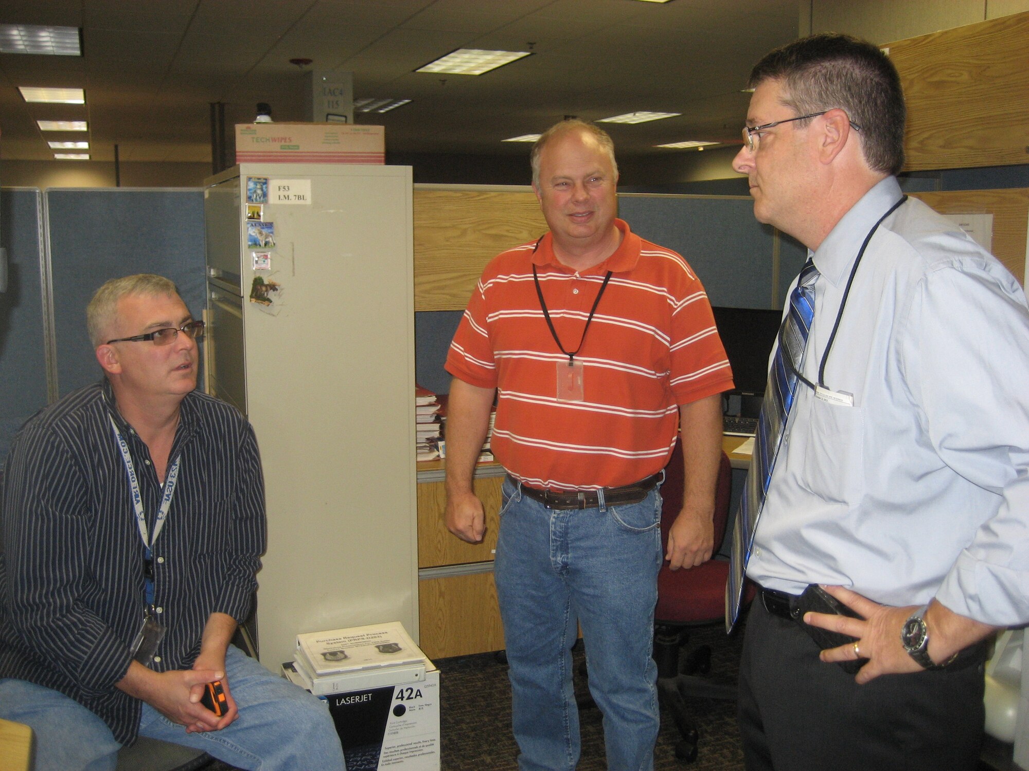 Steven Alsup, 448th Supply Chain Management Wing director, visits with Paul Anderson, left, and Tommy Sneed, both with the 421st Supply Chain Management Squadron. Commanders accros the Air Force Sustainment Center units at Tinker spent time with their people to reset focus on the mission after the stresses created by the government shutdown. (Air Force photo by Tamika Floyd) 