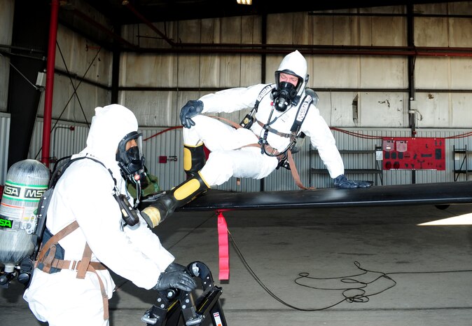 Senior Airman James Everson, 9th Maintenance Squadron aircraft fuels systems technician, steps down from the wing of a U-2 Dragon Lady Oct. 11, 2013, at Beale Air Force Base, Calif. Everson was conducting a hydrazine systems integrity check atop the aircraft. (U.S. Air Force photo by Airman 1st Class Bobby Cummings/Released)