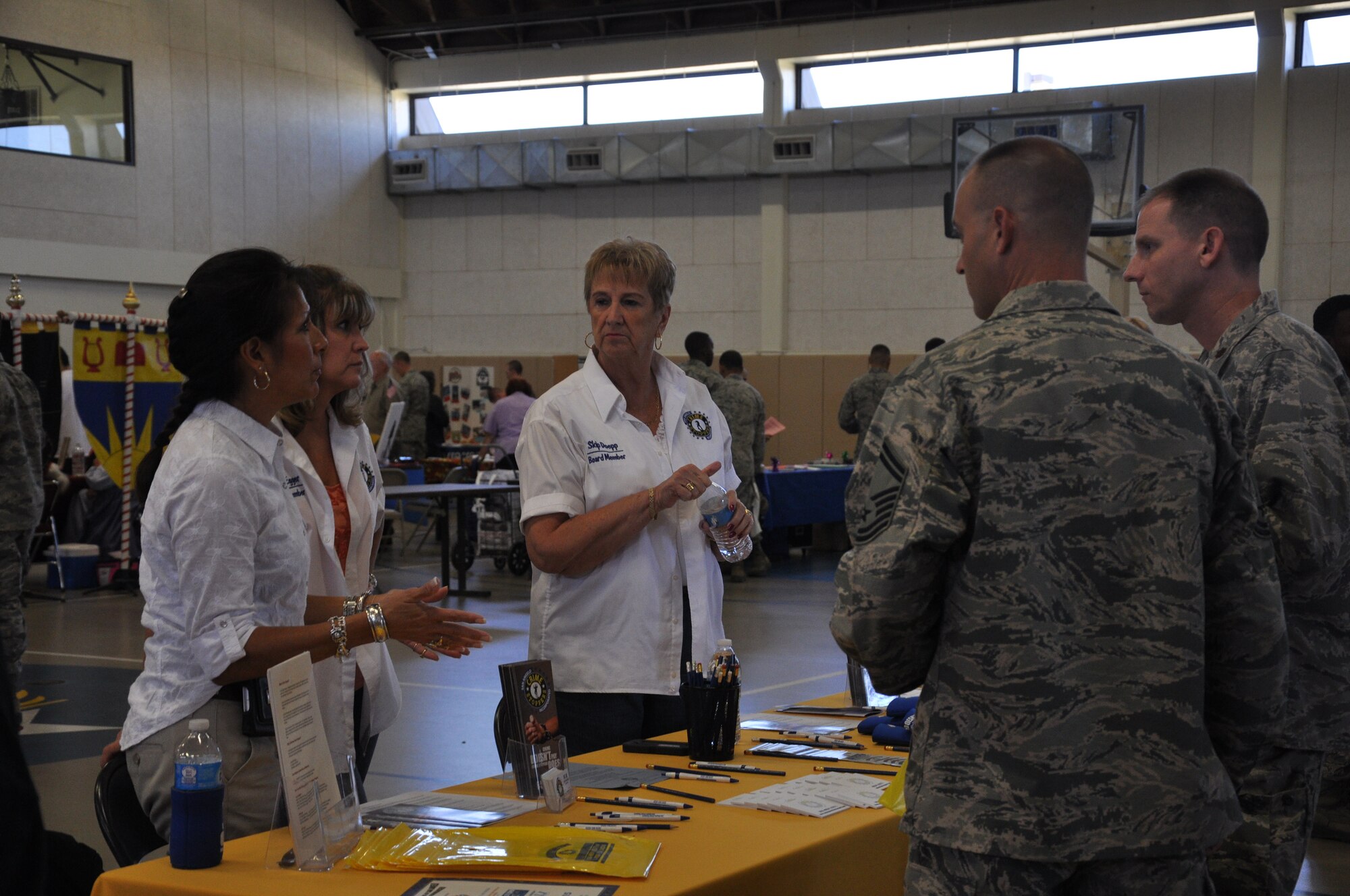 GOODFELLOW AIR FORCE BASE, Texas- Members from the non-profit organization, Crime Stoppers, talk to members from Goodfellow during the Volunteer Fair at the Carswell Fitness Center Oct. 9. Members were able to sign up at organizer booths of their choosing to receive information on volunteer opportunities. (U.S. Air Force photo/ Airman 1st Class Erica Rodriguez)