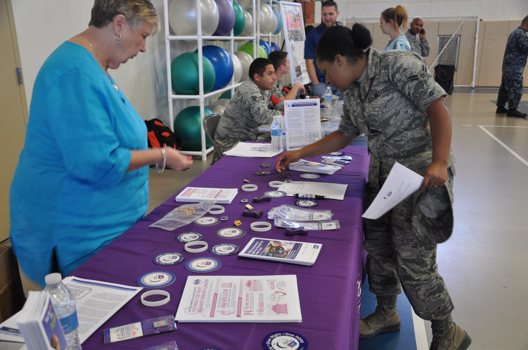GOODFELLOW AIR FORCE BASE, Texas- Airman 1st Class Breonna Veal, 17th Training Wing Public Affairs, gets information from the Relay for Life booth during the Volunteer Fair at the Carswell Fitness Center Oct. 9. The booths allowed non-profit organizations to bring information about what they do to members of Goodfellow. (U.S. Air Force photo/ Airman 1st Class Erica Rodriguez)