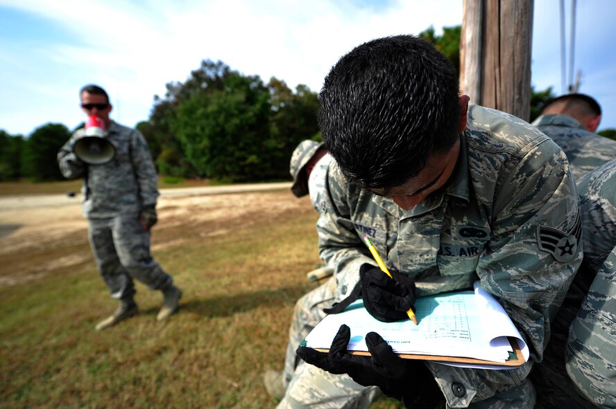 JOINT BASE MCGUIRE-DIX-LAKEHURST, N.J. -- Senior Airman Johny Martinez, 818th Global Mobility Readiness Squadron security forces fire team member and close precision engagement course candidate, records information after a stressed memorization exercise on a training range here Oct. 3.  Martinez and six other candidates were participating in a  621st Contingency Response Wing-run, 10-day CPEC indoctrination course to prepare them for the more rigorous 19-day U.S. Air Force CPEC course at Fort Bliss, Texas.  (U.S. Air Force photo by Tech. Sgt. Parker Gyokeres)
