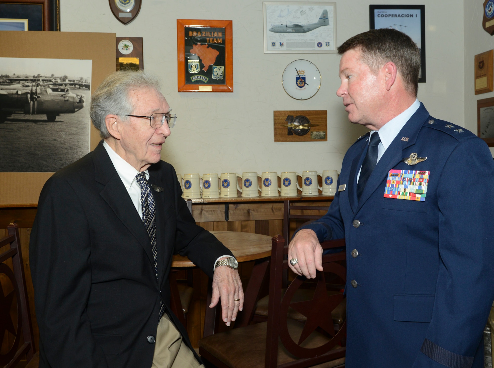 U.S. Air Force Maj. Gen. John F. Nichols, Texas adjutant general and commander, Texas Military Forces discusses the 28th mission of Thomas P. Faulkner, a former pilot and 1st. Lt. of the U.S. Army Air Forces’ 15th Air Force, in Italy during WWII where he earned his Distinguished Flying Cross in 1945. Faulkner is officially receiving his DFC 68 years after the fact at the 136th Airlift Wing, Naval Air Station Fort Worth Joint Reserve Base, Texas, Sept. 19, 2013. (Air National Guard photo by Senior Master Sgt. Elizabeth Gilbert/released)