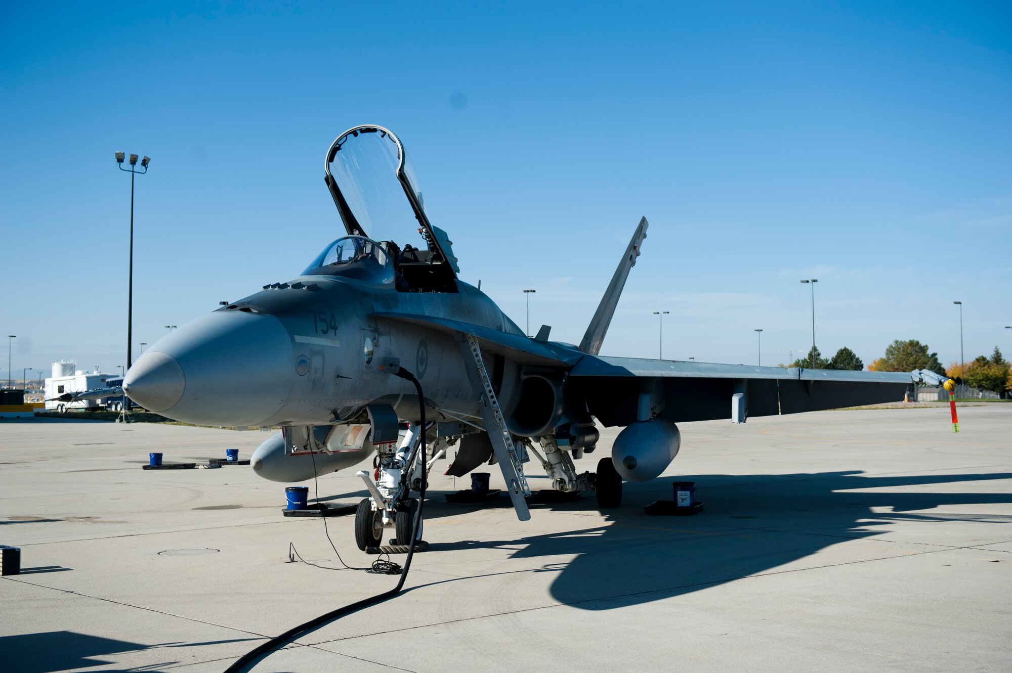 A CF-18 Hornet is being inspected by a Royal Canadian Air Force Airman at Gowen Field, Idaho, Oct. 11, 2013. Routine maintenance is performed on aircraft multiple times throughout the day to ensure the safety of the pilots flying them. (U.S. Air Force photo by Airman 1st Class Brittany A. Chase/Released)