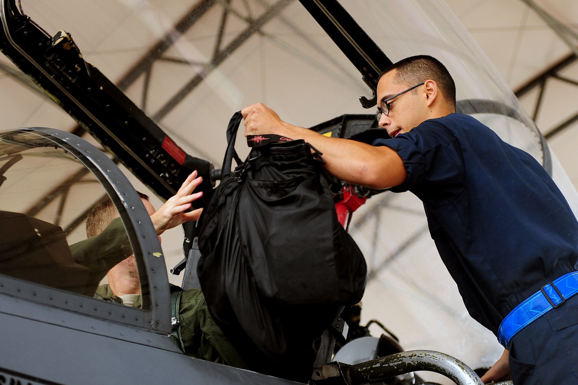 U.S. Air Force Airman 1st Class Daryl McCarthy, 4th Aircraft Maintenance Squadron crew chief, helps prepare an F-15E Strike Eagle pilot for flight at Seymour Johnson Air Force Base, N.C., Oct. 10, 2013.  The F-15E Strike Eagle has been in the Air Force’s arsenal for more than 25 years.  (U.S. Air Force photo by Airman 1st Class Brittain Crolley)