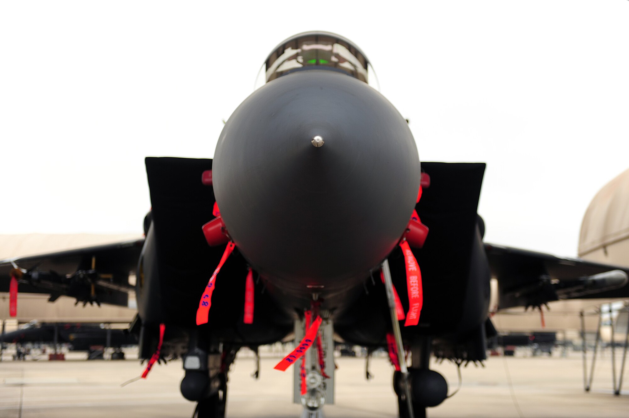 An F-15E Strike Eagle sits under a hangar at Seymour Johnson Air Force Base, N.C., Oct. 10, 2013.  The F-15E Strike Eagle was the first U.S. aircraft whose engines' thrust exceeded the plane's loaded weight, allowing it to accelerate even while in vertical climb.  (U.S. Air Force photo by Airman 1st Class Brittain Crolley)