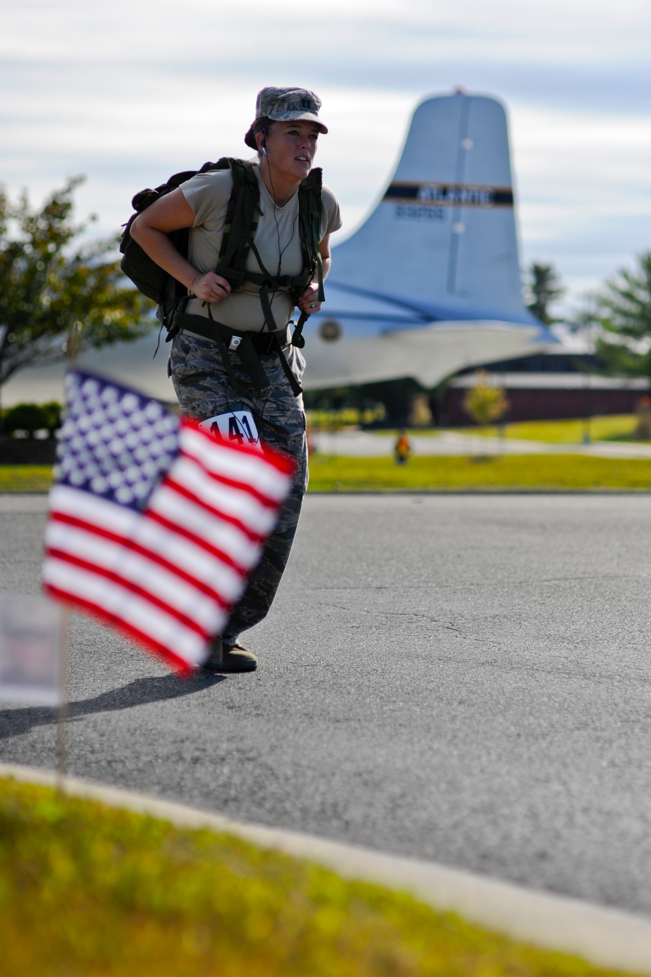 Capt. Amanda Demaye, 87th Mission Support Group executive officer, passes the McGuire Passenger Terminal circle during the 10K Gold Star Ruck March, Oct. 12, 2013, at Joint Base McGuire-Dix-Lakehurst, N.J. The participants each wore a 30-pound ruck sack to add to the challenge. (U.S. Air Force photo by Airman 1st Class Ryan Throneberry/Released)