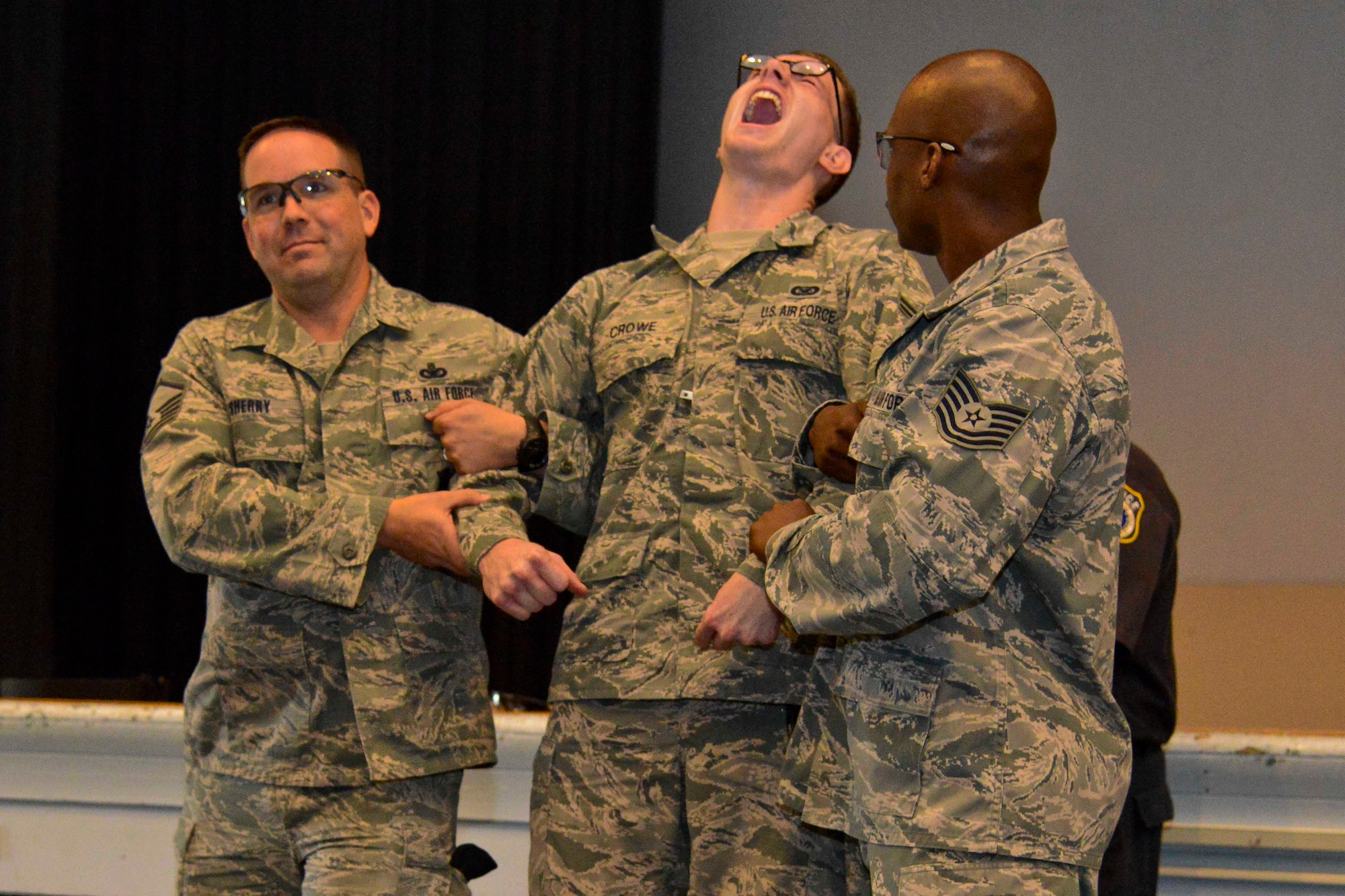 Airman 1st Class Sean M. Crowe, Joint Base McGuire-Dix-Lakehurst Public Affairs photojournalist, receives a voluntary exposure to a stun gun Oct. 8, 2013, in the Timmermann Center at JB MDL, N.J. Crowe volunteered to receive an exposure while learning about 87th Security Forces Squadron training for an article. (U.S. Air Force photo by Angel Lopez/Released)