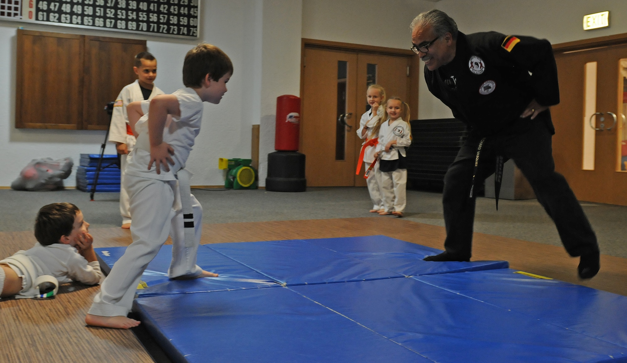 Richard Vasquez, Karate Tech class instructor, grapples with karate students during a Sumo wrestling demonstration, Oct. 8, 2013, Vogelweh, Germany. The Karate Tech class helps gain self-discipline, experience in martial arts and enhance physical fitness to KMC members. (U.S. Air Force photo/Airman 1st Class Holly Mansfield)