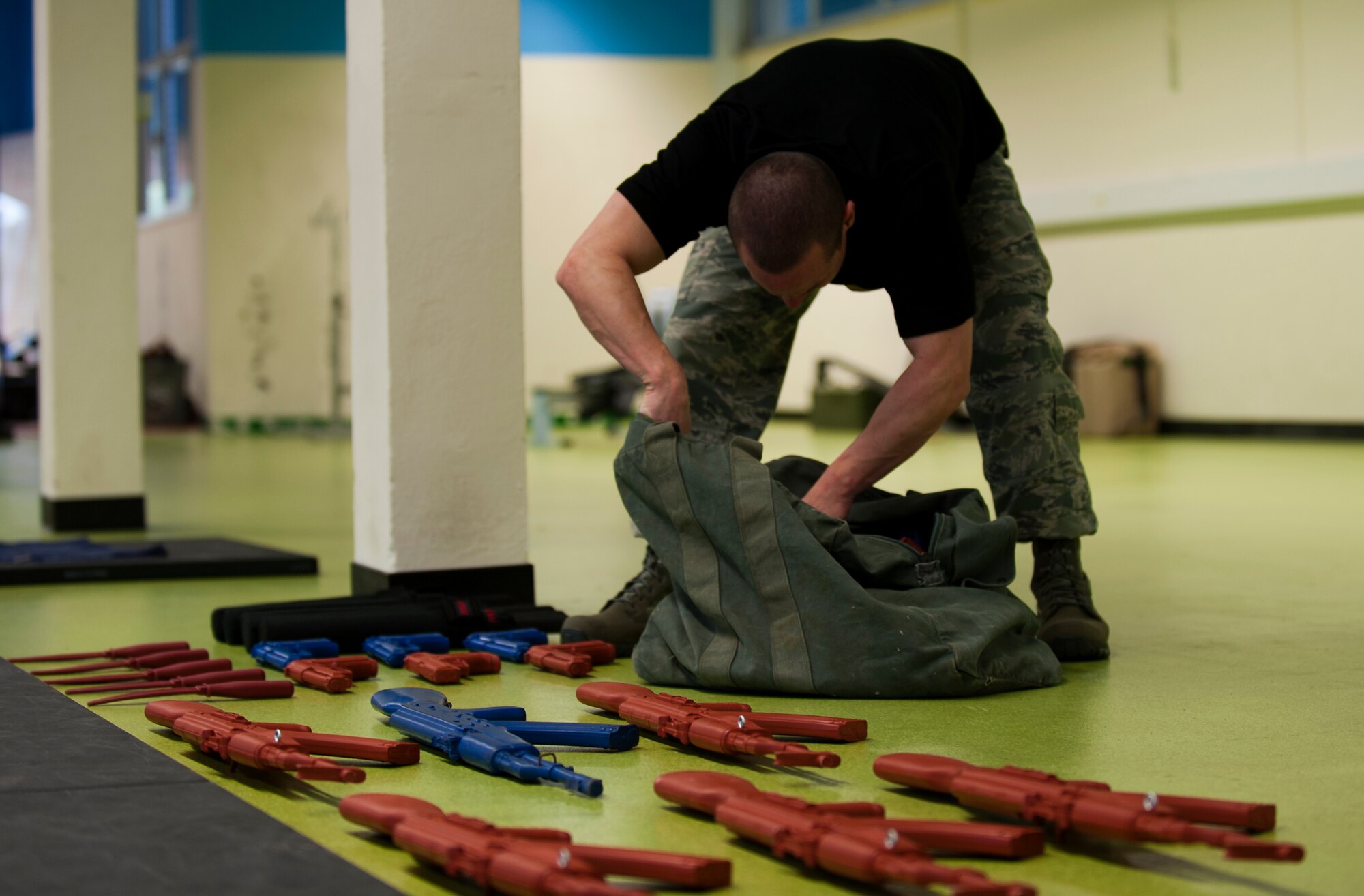 Staff Sgt. Joshua R. Marugg, 435th Security Forces Squadron fly-away security team NCOIC, prepares training weapons for instructing the weapons retention and take-away portion of a F.A.S.T. course, Oct. 9, 2013, Pulaski Barracks, Germany. During the course, Airmen have the opportunity to learn how to deal with a variety of weapons hostiles may be equipped with. (U.S. Air Force photo/Airman 1st Class Damon Kasberg)