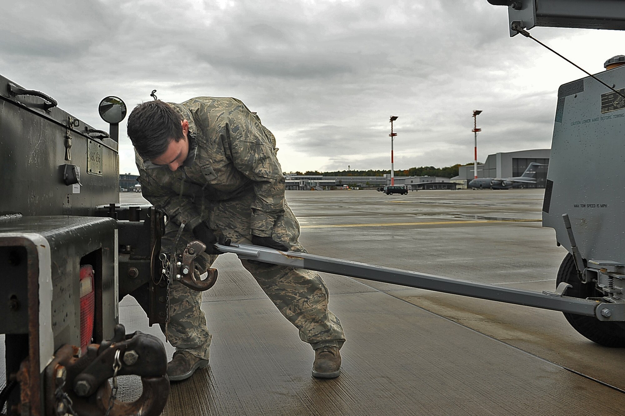 Airman 1st Class, Jonathan Penata, 86th Maintenance Squadron Aerospace Ground Equipment technician, connects a generator to a truck to move it to a C-17 Globemaster III so that it may power the aircraft during pre-flight checks, Oct. 10, 2013, Ramstein Air Base Germany. 86th AGE flight maintains all ground equipment for any aircraft coming through Ramstein. (U.S. Air Force photo/ Senior Airman Aaron-Forrest Wainwright)