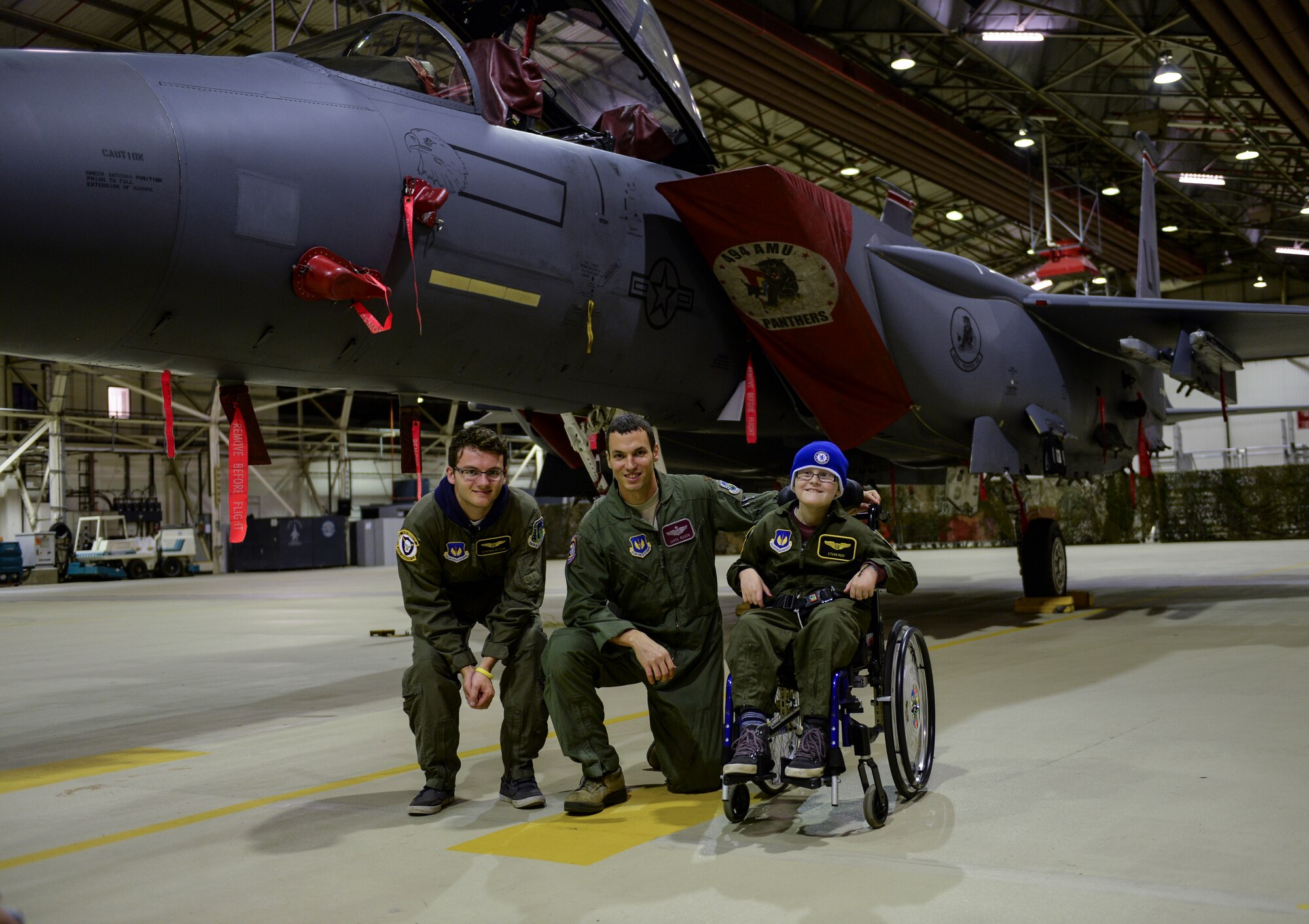 Maj. Jason Bianchi, 48th Operations Support Squadron chief of current operations (center), poses with Pilot for a Day participants, Stephen Sutton (left) and Ethan Ridd in front of an F-15E Strike Eagle at Hangar 7 on Royal Air Force Lakenheath, England, Oct. 10, 2013. Pilot for a Day, started in 2012, gives local-community children with serious illnesses a day away from routine hospital visits to see the Air Force. (U.S. Air Force photo by Airman 1st Class Nigel Sandridge/Released)