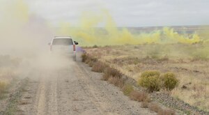 Opposition Force personnel hide inside green, yellow and purple colored smoke as Marines from 1st Air Naval Gunfire Liaison Company drive through it as part of combat search and rescue training Oct. 14, 2013, at the Saylor Creek range.  Hundreds of German Airmen and Soldiers, Royal Canadian Airmen, U.S. Marines, Sailors, Soldiers and Airmen are utilizing Mountain Home Air Force Base, Idaho, for a variety of training scenarios during Mountain Roundup 2013. (U.S. Air Force photo by Senior Airman Benjamin Sutton/RELEASED)
