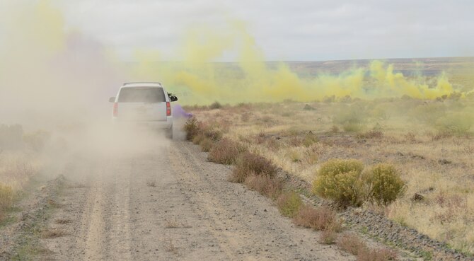 Opposition Force personnel hide inside green, yellow and purple colored smoke as Marines from 1st Air Naval Gunfire Liaison Company drive through it as part of combat search and rescue training Oct. 14, 2013, at the Saylor Creek range.  Hundreds of German Airmen and Soldiers, Royal Canadian Airmen, U.S. Marines, Sailors, Soldiers and Airmen are utilizing Mountain Home Air Force Base, Idaho, for a variety of training scenarios during Mountain Roundup 2013. (U.S. Air Force photo by Senior Airman Benjamin Sutton/RELEASED)
