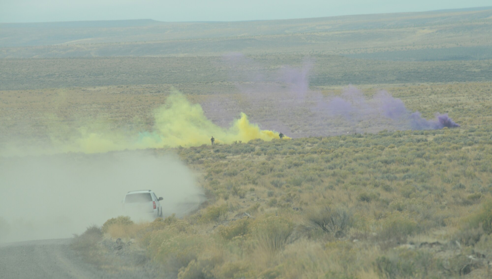 Opposition Force personnel hide inside green, yellow and purple colored smoke as Marines from 1st Air Naval Gunfire Liaison Company extract two downed German Air Force pilots as part of combat searcha dn rescue training Oct. 14, 2013, at the Saylor Creek range.  A multitude of various aircraft and servicemembers have been busy at Mountain Home Air Force Base, Idaho, since Sept. 30 during the multinational combined-joint exercise dubbed Mountain Roundup 2013. (U.S. Air Force photo by Senior Airman Benjamin Sutton/RELEASED)

