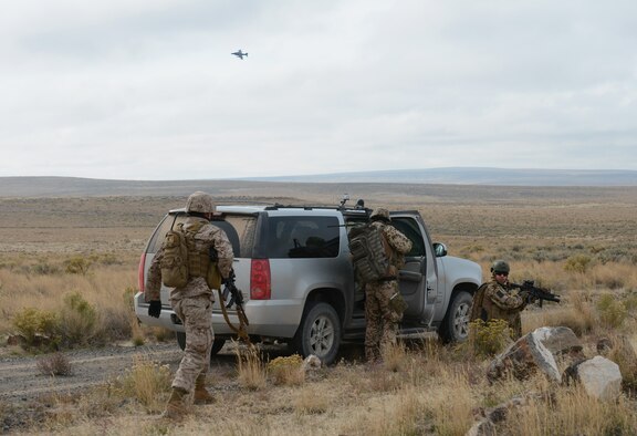 Marines from 1st Air Naval Gunfire Liaison Company along with German Air Force joint terminal attack controllers exit their vehicles and prepare to meet wih aircrew during a combat search and rescue exercise Oct. 14, 2013, at the Saylor Creek range. While much of the U.S. Federal Government has been shut-down since Oct. 1, the troops here have been busy "fighting" the exercise, which is part of the German Air Force Tornado Fighter Weapons Instructor Course Mission Employment (ME) Phase, and is scheduled to end Oct. 16. (U.S. Air Force photo by Senior Airman Benjamin Sutton/RELEASED) 
