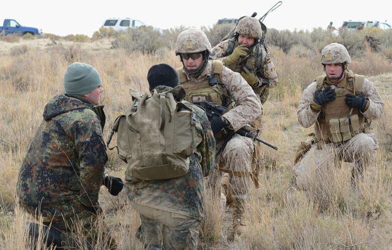 Marines from 1st Air Naval Gunfire Liaison Company and German Air Force joint terminal attack controllers speak with aircrew during a search and rescue training exercise Oct. 14, 2013, at Saylor Creek range. More than 300 Germans and Canadians, and an equal number of U.S. Navy, Marine Corps, Army and Air Force are participating in ground operations, close-air support, urban combatives, convoy operations, basic fighter maneuvers, counter air and multiple air-to-air training scenarios. (U.S. Air Force photo by Senior Airman Benjamin Sutton/RELEASED)

