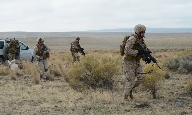 Marines from 1st Air Naval Gunfire Liaison Company along with German Air Force joint terminal attack controllers perform combat search and rescue training Oct. 14, 2013, at the Saylor Creek range. "During this whole Mountain Roundup exercise, we've been partnering with the Germans and training as a combined unit aimed at the same objectives," said Marine Capt. Erich Lloyd, 1st ANGLICO forward air controller. "Training with our allies is a very important role for us because we are the liaison for coalition partners." (U.S. Air Force photo by Senior Airman Benjamin Sutton/RELEASED)