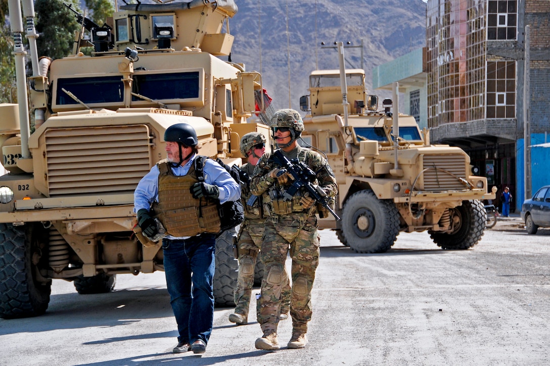 U.S. Army 1st Lt. Robert Wolfe, right, escorts Jim Otwell, left, a U.S ...