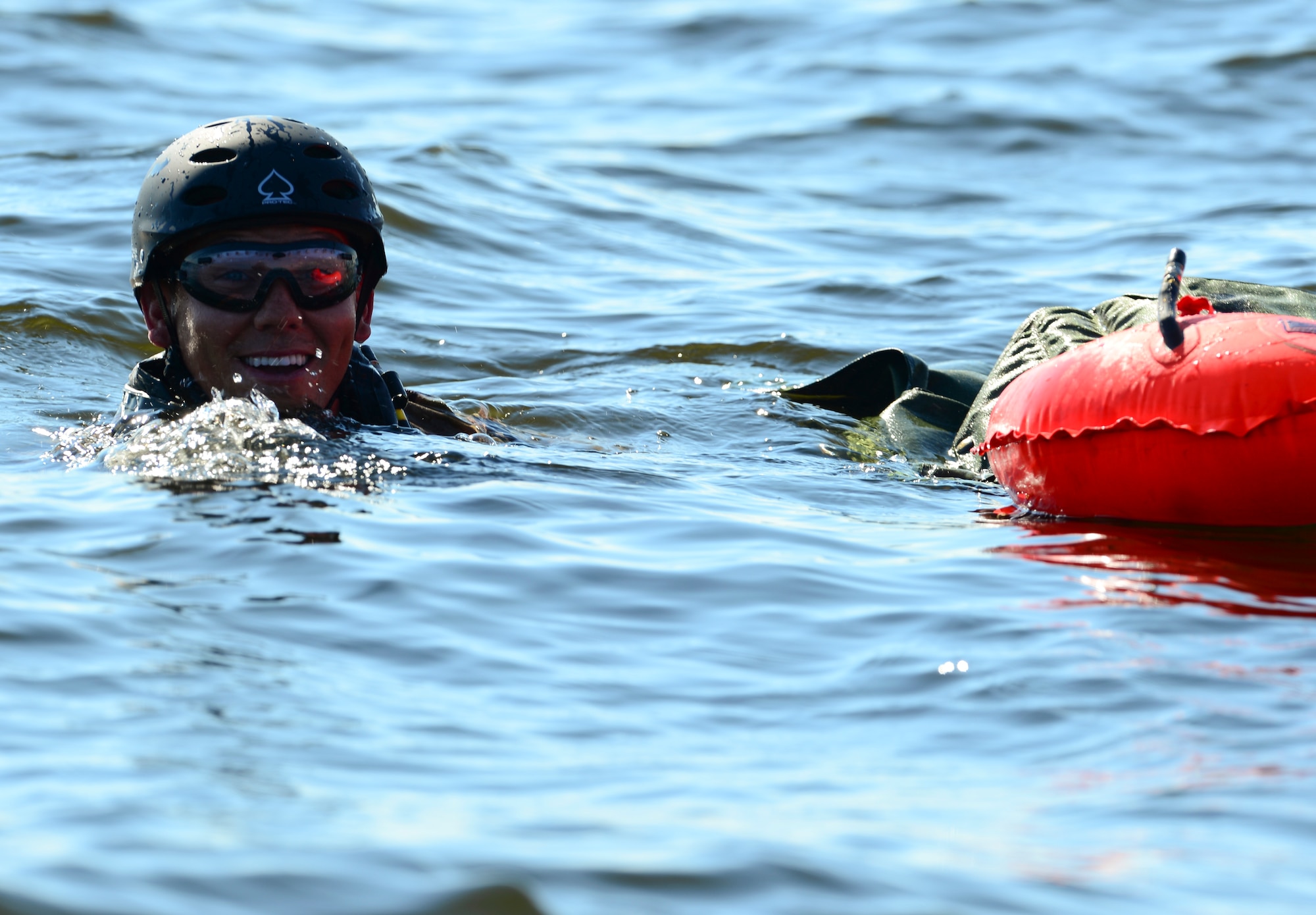 Staff Sgt. Johnnie Yellock Jr. swims after completing his final free fall jump before being medically retired Oct. 16, 2013, at Hurlburt Field, Fla. Yellock endured 28 surgeries and two years of intense physical therapy to be able to walk again after his vehicle was struck by an improvised explosive device during a 2011 deployment to Afghanistan. Yellock is a 23rd Special Tactics Squadron combat controller. (U.S. Air Force photo/Staff Sgt. John Bainter)