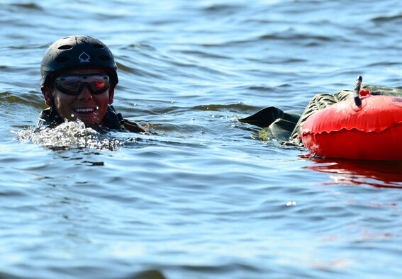 Staff Sgt. Johnnie Yellock Jr. swims after completing his final free fall jump before being medically retired Oct. 16, 2013, at Hurlburt Field, Fla. Yellock endured 28 surgeries and two years of intense physical therapy to be able to walk again after his vehicle was struck by an improvised explosive device during a 2011 deployment to Afghanistan. Yellock is a 23rd Special Tactics Squadron combat controller. (U.S. Air Force photo/Staff Sgt. John Bainter)
