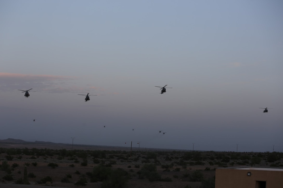 More than 10 UH-1Y Huey helicopters containing Marines with Animal Company, 1st Battalion, 7th Marine Regiment, assault a mock town during a raid exercise here, Oct. 9, 2013. The Animal Co. Marines inserted into a training town by fast roping from the helicopters and engaged enemy role players while a designated team captured a suspected high-ranking insurgent. The company conducted the raid as part of the Weapons and Tactics Instructor Course in preparation for their deployment to Afghanistan this spring.
