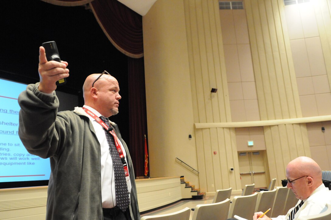 Jason Terry, chemical, biological, radiological and nuclear protection officer, instructs Quantico employees on how to shelter in place during a chemical release on Oct. 10, during one of several trainings at Little Hall. 