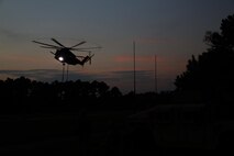 A CH-53E Super Stallion with Marine Heavy Helicopter Squadron 461 descends before dropping a payload for training operations with Landing Support Platoon, Combat Logistics Battalion 24, 2nd Marine Logistics Group during a battalion exercise aboard Camp Lejeune, N.C., Oct. 17, 2013. LS Plt. and HMH-461 completed day training with an 8,000-pound beam and night operations with the beam and a 500-gallon water bladder provided by water purification Marines with the battalion. 