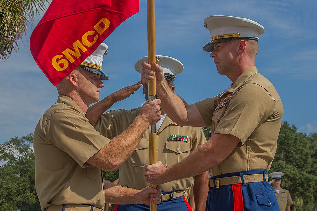 Capt. Barry Morris, 6th Marine Corps District Headquarters Company Commander, relinquishes command to Capt. Alan Thompson, supply officer of District Headquarters, during the change of command ceremony at District Headquarters aboard Parris Island, S.C., Oct. 18, 2013. Morris’ follow on assignment will be as the Public Affairs Officer for Marine Forces Special Operations Command, Camp Lejeune, N.C. (U.S. Marine Corps photo by Lance Cpl. John-Paul Imbody)