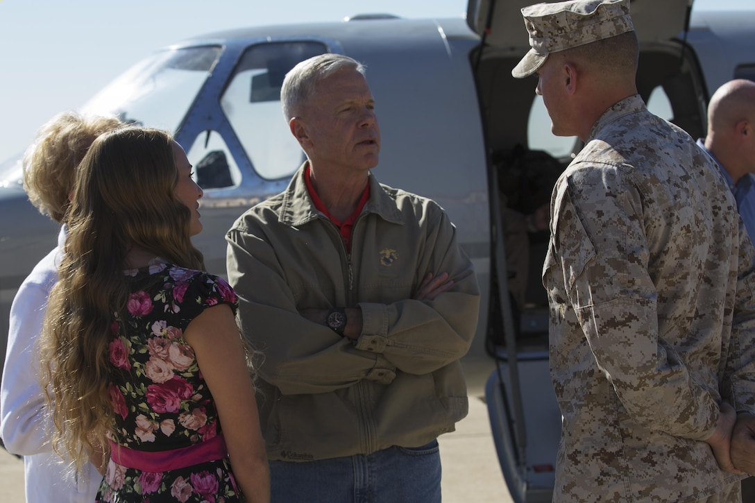 Commandant of the Marine Corps, Gen. James F. Amos, and First Lady of the Marine Corps, Bonnie Amos, are greeted by Sgt. Christopher Prior, a field wireman with Marine Wing Communications Squadron 38 and a Cedar Rapids, Iowa native and his wife, Paige Prior, aboard Marine Corps Air Station Miramar, Calif., Oct 17. This past May, Prior led a colors ceremony celebrating Marine Corps spouses.  He and his wife were hand-selected to personally greet the Commandant and his wife as part of the 3rd Marine Aircraft Wing commanding general, Maj. Gen, Steven Busby’s, Committed and Engaged Leadership and Committed and Engaged Spouse campaigns.