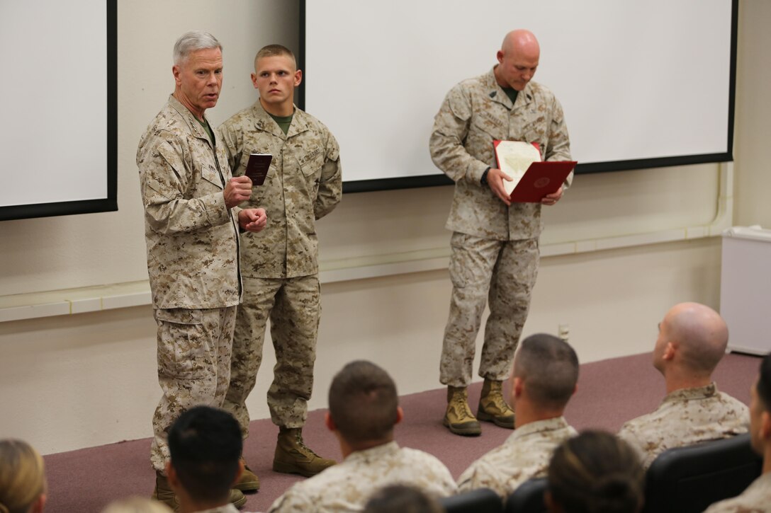 Commandant of the Marine Corps, Gen. James F. Amos, and Sergeant Major of the Marine Corps, Sgt. Maj. Micheal P. Barrett, promote now Cpl. Wesleigh Beckman, an aviation ordinance technician with Marine Aviation Logistics Squadron 11 and a Fairfield, Ohio native to his current rank aboard Marine Corps Air Station Miramar, Calif., Oct. 17. During the ensuing informal seminar Amos and Barrett emphasized the importance of the Marine noncommissioned officer.