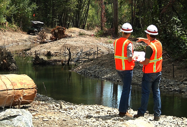 Kelly Janes, left and Zak Talbott, San Francisco District Department of the Army interns, review project plans alongside the completed Reach 15 Restoration Project at Lake Sonoma August 8.