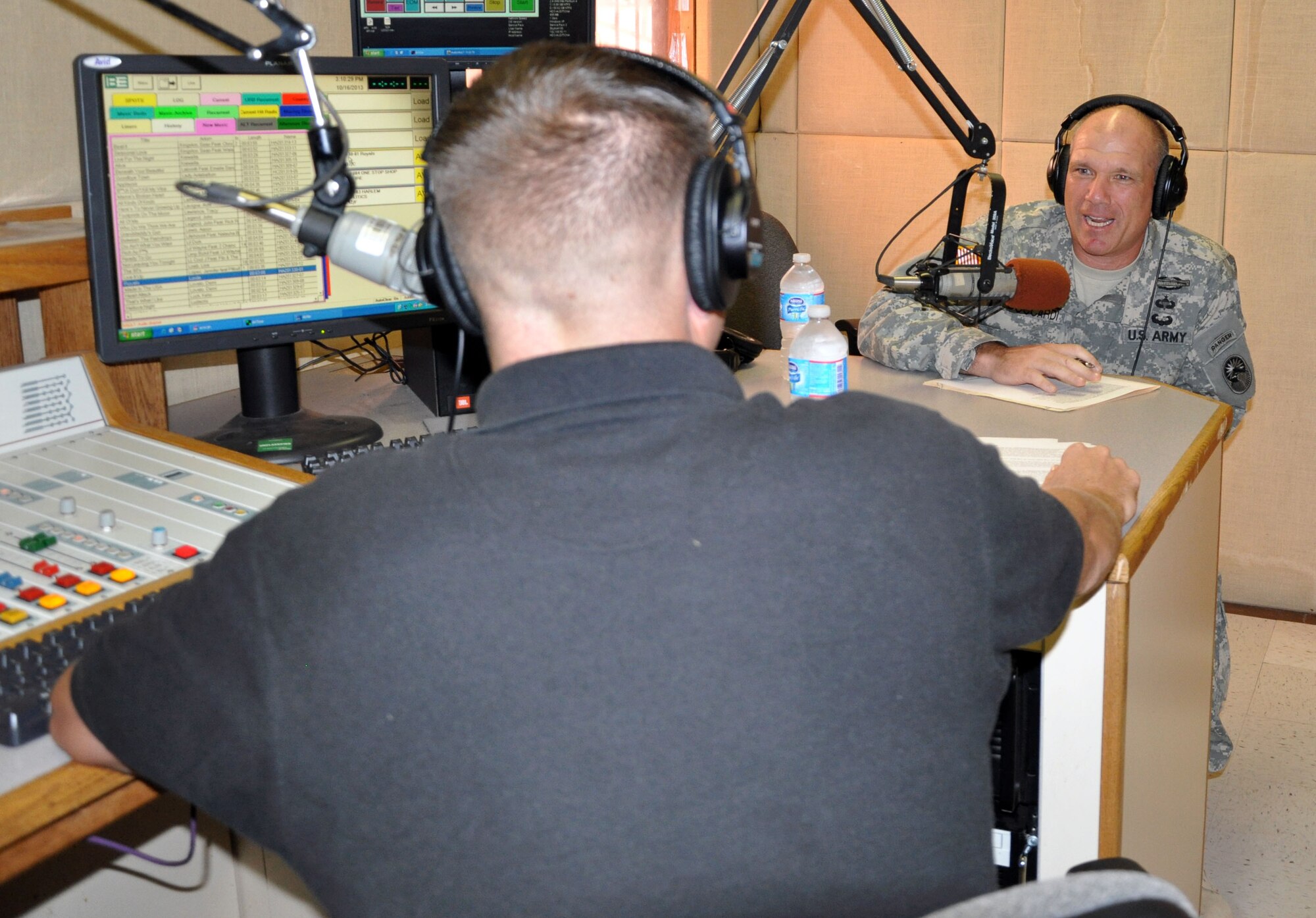 U.S. Army Col. Thomas Boccardi, Joint Task Force-Bravo commander, paid a visit to the American Forces Network-Honduras radio studio, Oct. 16, 2013. Col. Boccardi was hosted live on the air by U.S. Army Staff Sgt. Michael Sparks. The commander discussed several current issues affecting members of Joint Task Force-Bravo. (U.S. Air Force photos by Capt. Zach Anderson) 