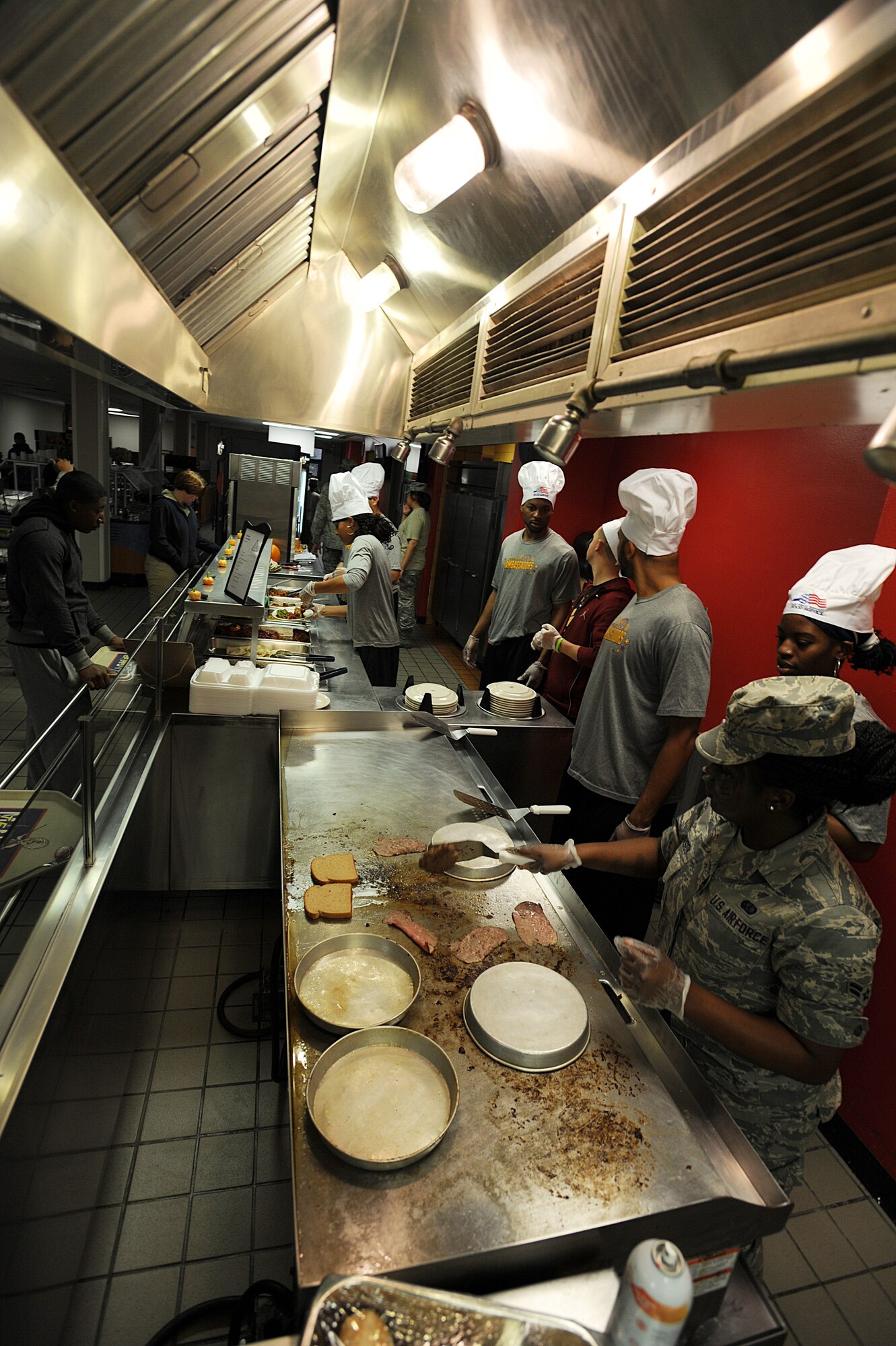 Members from the Harlem Ambassadors Basketball team helped cook and serve meals to Team Minot’s Airmen at the Dakota Inn Dining Facility, Oct. 17. As part of their visit, the team also took part in a basketball exhibition game at the McAdoo Sports and Fitness Center and visited students at the Youth Center. (U.S. Air Force photo/Senior Airman Jose L. Hernandez)