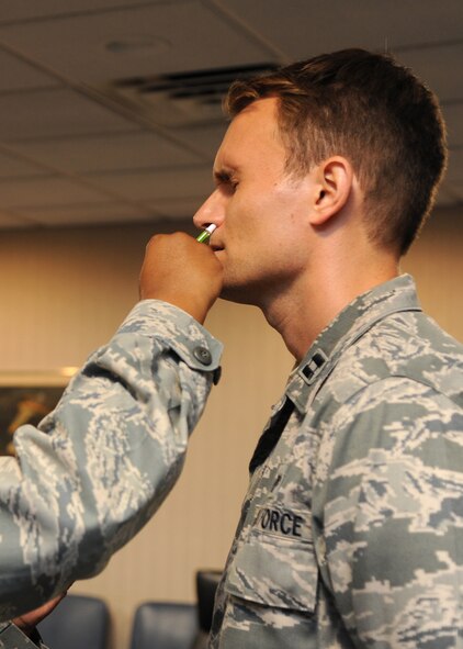 Staff Sgt. Robrielle Dotson, 2nd Medical Group immunizations technician, gives Capt. Phillip Ventura, 2nd Bomb Wing Chief of Public Affairs, an influenza mist at the General Dougherty Conference Center on Barksdale Air Force Base, La., Oct. 18, 2013. In accordance with the Center of Disease control, all Department of Defense members are required to receive a flu vaccination. (U.S. Air Force photo/Senior Airman Joseph A. Pagán Jr.)