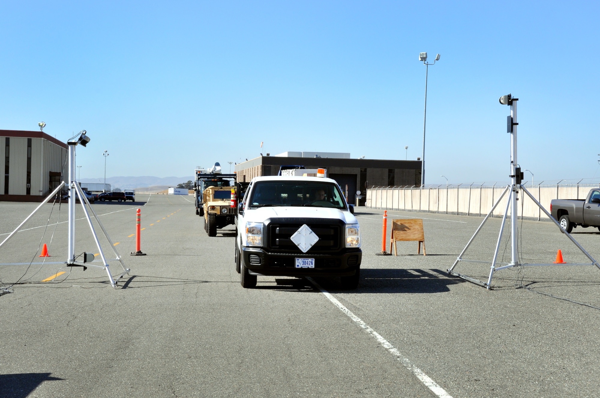 Staff Sgt. Jestin Kesee, 60th APS special handling, drives a stake-bed truck through the laser portion of the DACMS where the vehicles length, width and height will be calculated. (U.S. Air Force photo/Staff Sgt. Patrick Harrower)