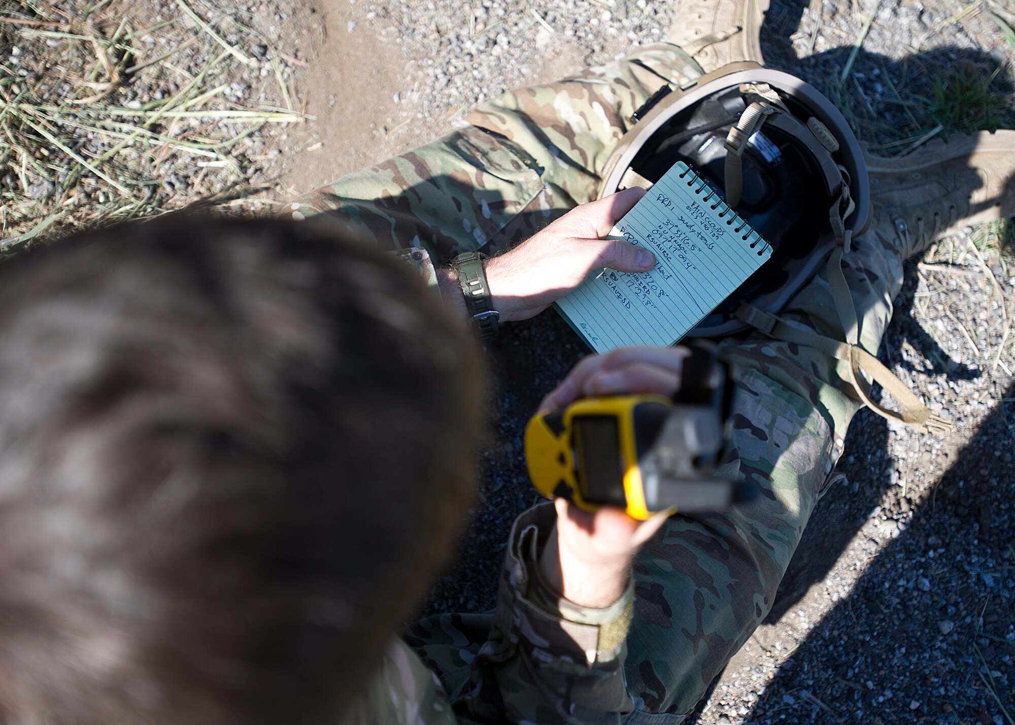 Tech. Sgt. Justin Watters, 22nd Operation Support Squadron SERE NCO in charge, broadcasts an encrypted code with survival, evasion, resistance and escape refresher training participants Oct. 10, 2013, in Derby, Kan. This refresher course is mandatory for  aircrew to complete once every three years. After the classroom session, the participants evaded capture and navigated their way through the woods to specific points, including a simulated rescue point. (U.S Air Force photo/Senior Airman Katrina M. Brisbin