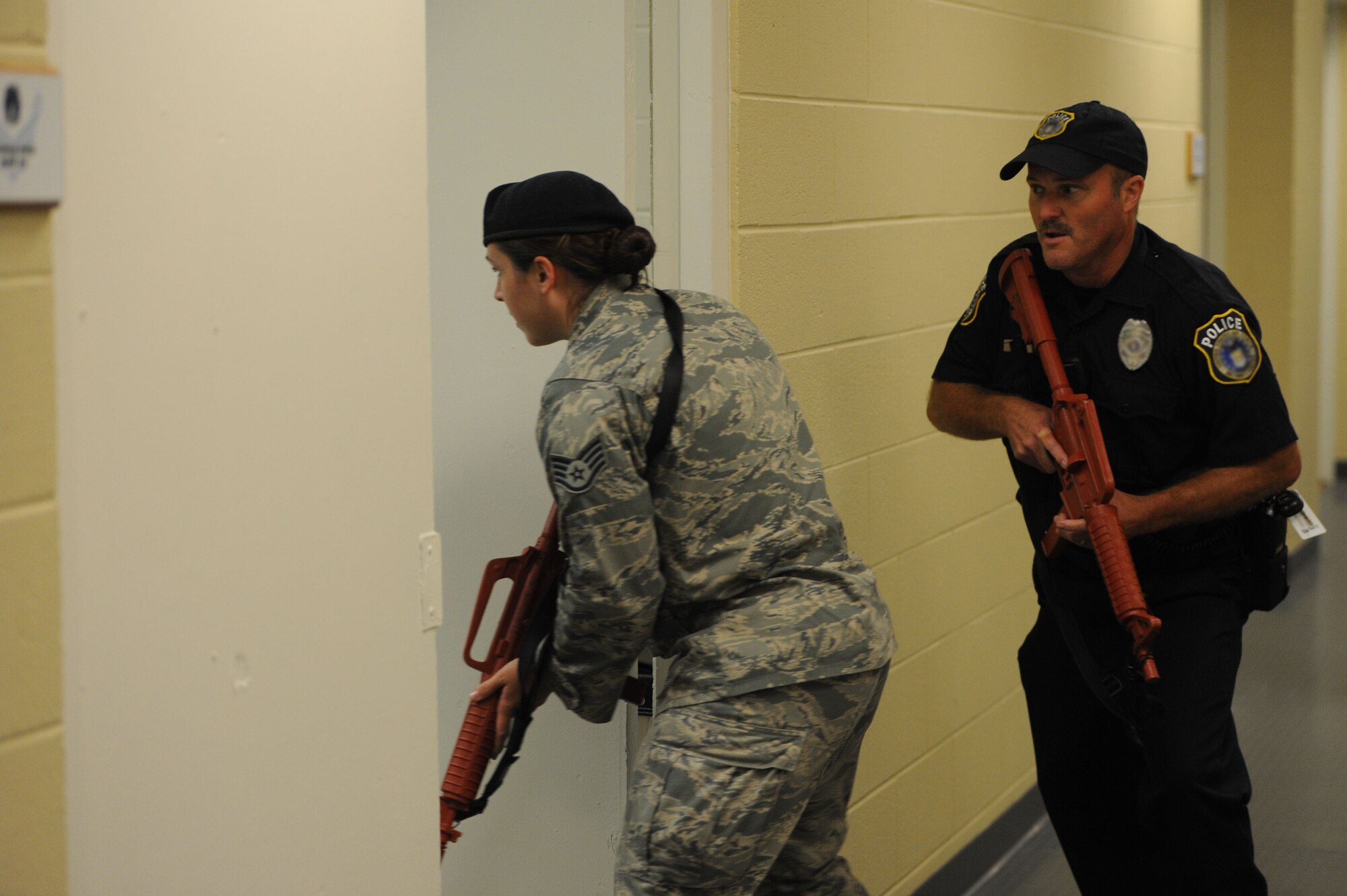 Staff Sgt. Cynthia Allen, 81st Security Forces Squadron, and Officer Bryan Beecher, 81st SFS, clear rooms of Maltby Hall during an active shooter exercise at the 85th Engineering Installation Squadron compound Oct 17, 2013, Keesler Air Force Base, Miss. The active shooter exercise was the first of its kind to prepare the 85th EIS compound for the 81st Security Forces Squadron’s response time during a real world incident. (U.S. Air Force photo by Airman 1st Class Stephan Coleman)