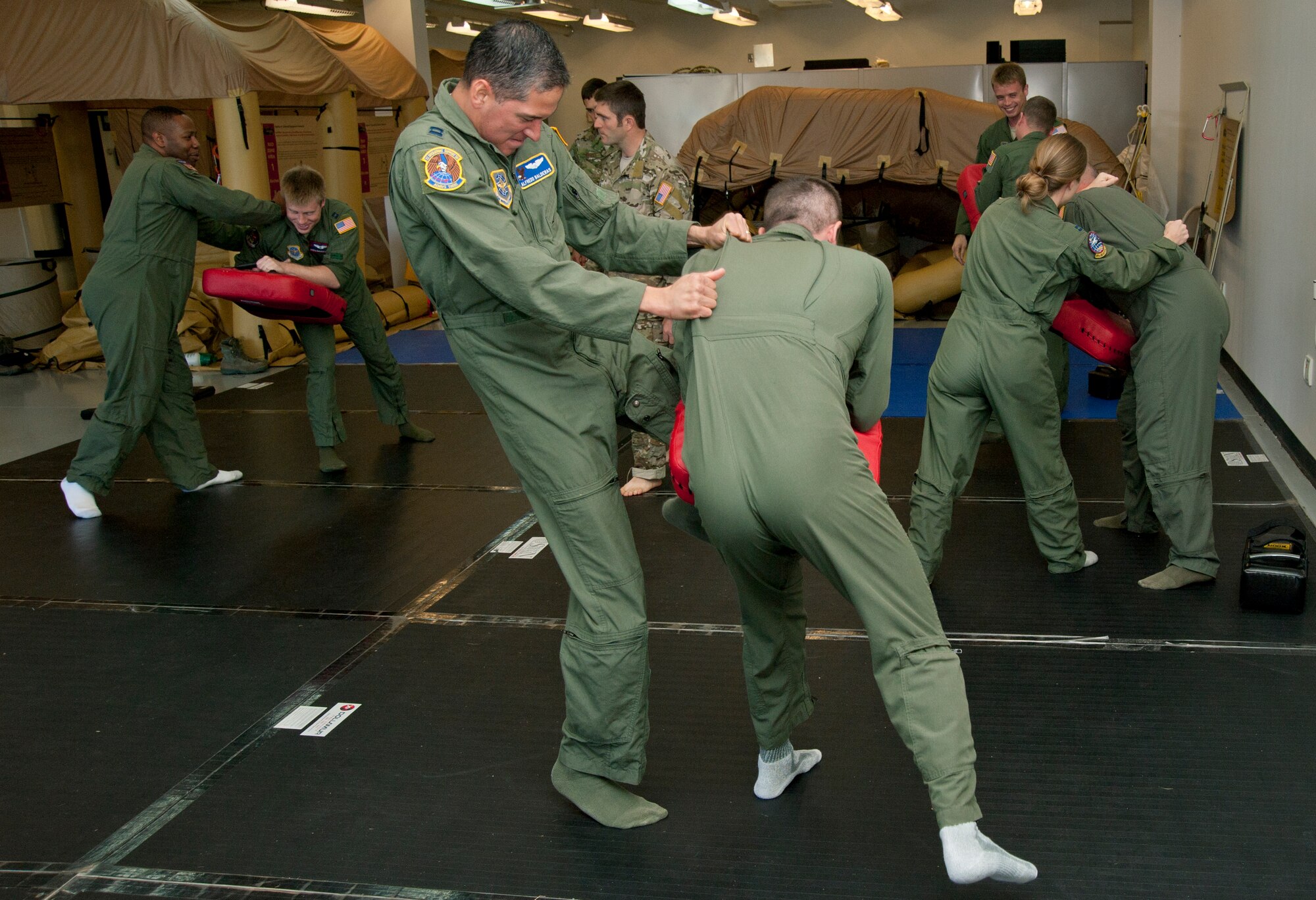 Capt. Alfredo Balderas, 22nd Operations Support Squadron aircrew flight equipment flight commander and pilot, knees an opponent during the U.S. Army combatives portion of combat survival training Oct. 8, 2013, at McConnell Air Force Base, Kan. The combatives portion of the class taught Airmen defensive moves to use during a physical confrontation. (U.S. Air Force photo/Airman 1st Class Victor J. Caputo)